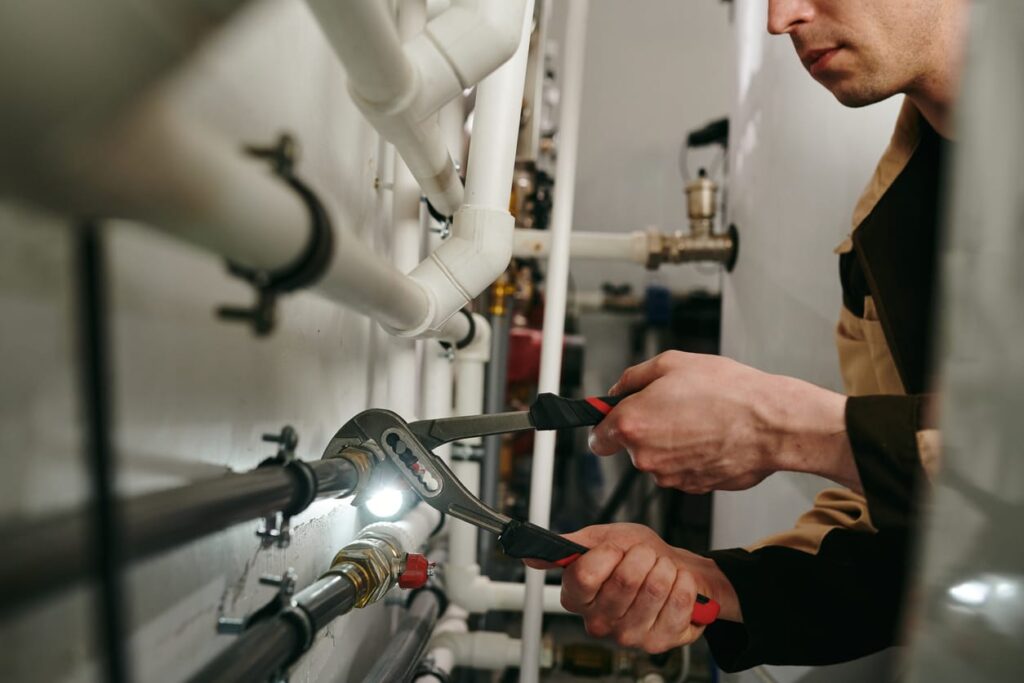 Plumbers maintaining commercial plumbing pipes in Commerce City