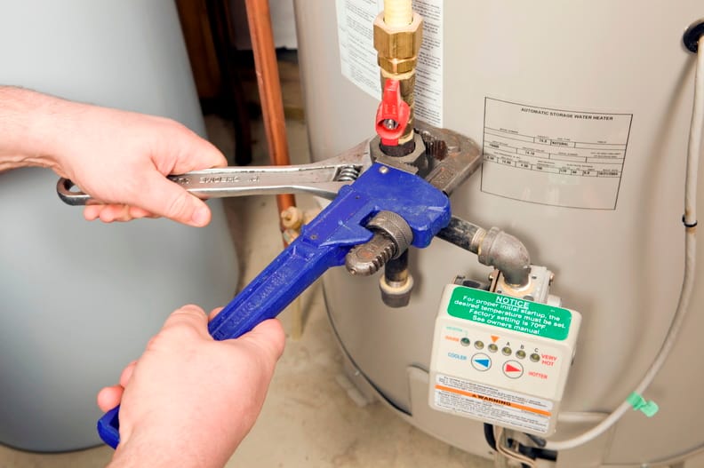 Plumber repairing a water heater valve in Commerce City